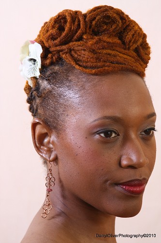 Brown colored dreadlock updo hairstyle