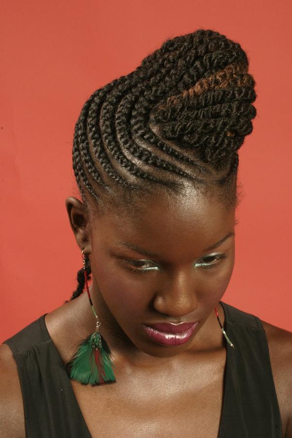 Braids and twists hairstyle with a rolled bun front thirstyroots 
